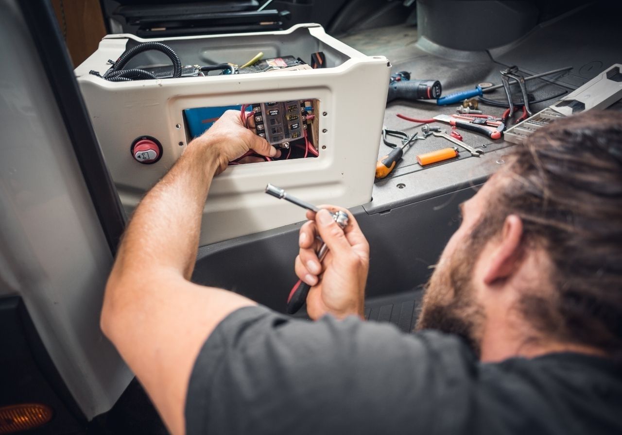 RV owner dealing with power outage and electrical failure while camping