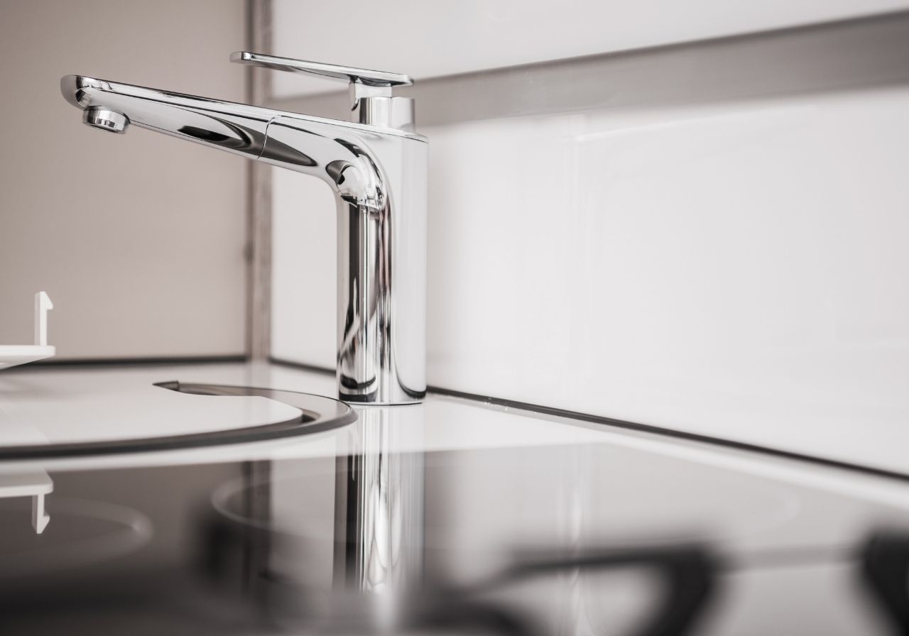RV sink with active leak being inspected for emergency plumbing repair